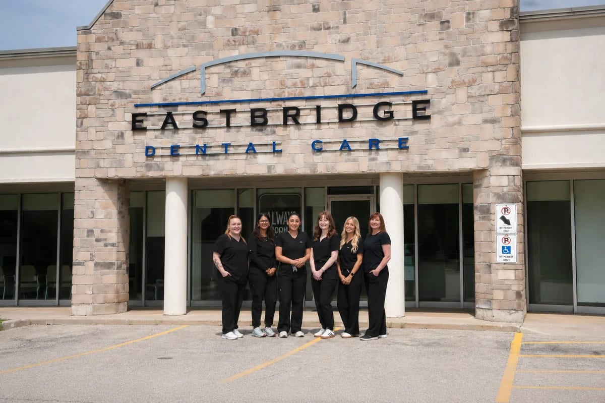 The Eastbridge Dental Care team standing together in front of the clinic